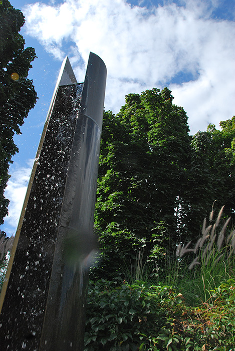 <strong><i>Le passage du 2 avril</i></strong><BR>2001<BR>Sculpture-fontaine, laiton et aménagement de la place, béton et granit<BR>6 colonnes de laiton, 358 cm de hauteur x 38 cm de diamètre<BR><i></i><BR><BR><br><h9 style='font-size:.8em'>Photo : Simon Meloche<br>5/7</h9><BR><br><br><h9 style='font-size:.8em'>© Succession Charles Daudelin /COVA-DAAV